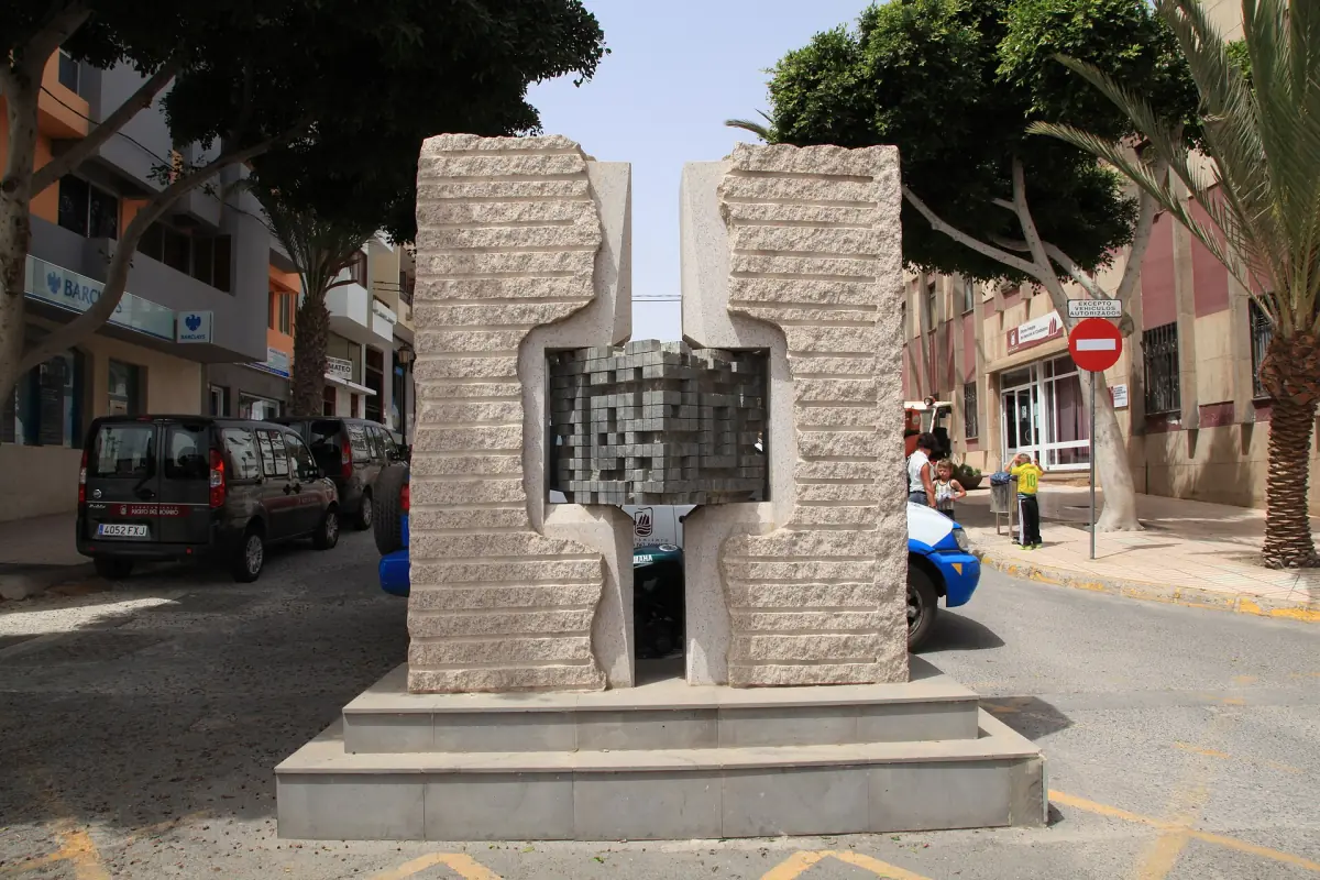 A stone sculpture on a street in Puerto del Rosario